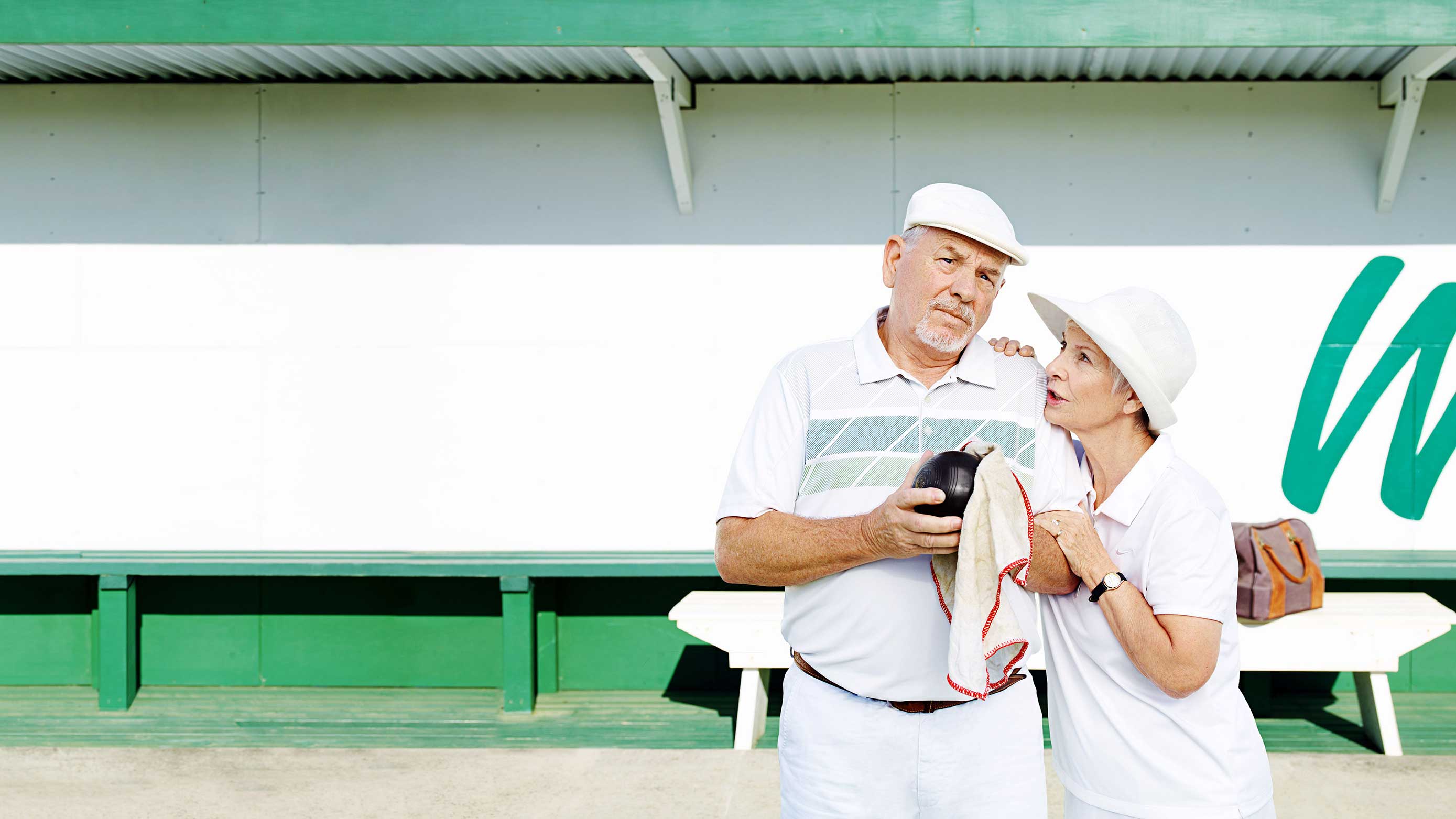 An older couple getting ready to play bowls