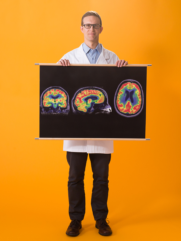 scientist holding brain scan